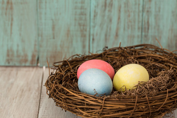 Naklejka na ściany i meble Three Colorful Easter Eggs in a Nest