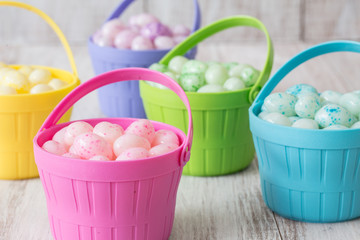Fototapeta na wymiar Pastel Jelly Beans in Bright Colored Baskets for Easter