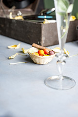 Pink rose in a glass on a background of a gramophone