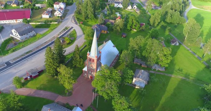 Old catholic church building. Aerial footage. Camera around.