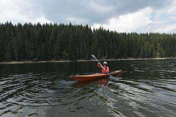 Woman paddling with her sit-in kayak