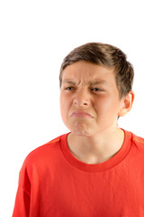 Obraz premium Young teenage boy isolated on a white background wrinkling his nose