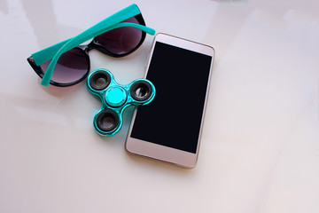Spinner, sunglasses for the phone, spend the summer holidays. Modern toy for hands