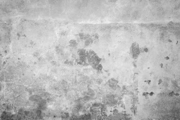 Weathered and aged concrete wall, paint peeled off. Texture background with vignetting in black and white.