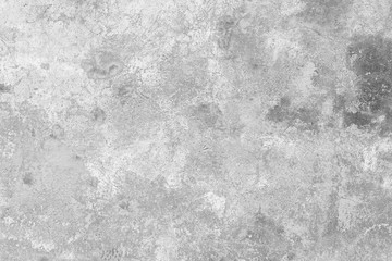 Close-up of a weathered and aged concrete wall, paint partly peeled off. Texture background in black and white.