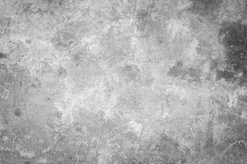 Fototapeta na wymiar Close-up of a weathered and aged concrete wall, paint partly peeled off. Texture background in black and white with vignette.