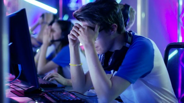 Team of Teenage Gamers Loose Video Game Tournament. Boys and Girls Look Very Upset. Shot on RED EPIC-W 8K Helium Cinema Camera.