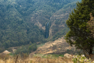 Fototapeta na wymiar Waterfall and sown in the mountains, Guatemala