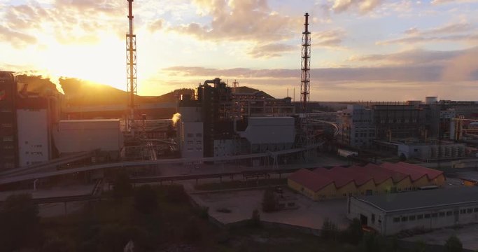 Aerial view Oil refinery with a background of mountains and sky at sunset. Aerial footage.