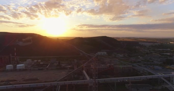 Aerial view Oil refinery with a background of mountains and sky at sunset. Aerial footage.