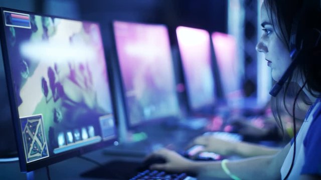 Professional Players Put on Headsets and Start Playing in MMORPG/ Strategy Video Game on Their Computers. Team Participates in Online Cyber Games Tournament/  Playing in Internet Cafe. 4K UHD.