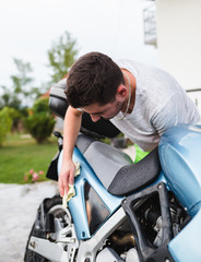 A man cleaning motorcycle - motorcycle detailing (or valeting) concept. Selective focus. 