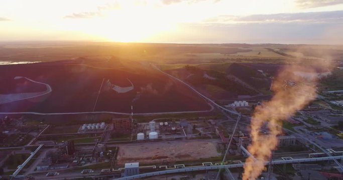 Aerial view Oil refinery with a background of mountains and sky at sunset. Aerial footage.