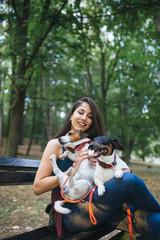 Dog walker with dogs enjoying in park.