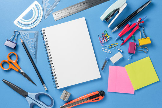 Notepad, School stationery and office supplies on color background.