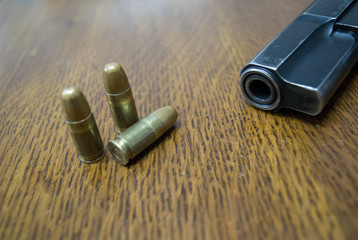 9mm gun on the table and some bullets