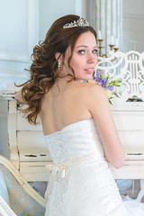 Young attractive bride on wedding gown in studio