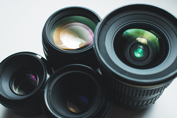 close-up view of a group of camera lenses on a white surface