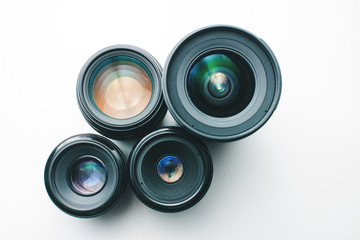 close-up view of a group of camera lenses on a white surface