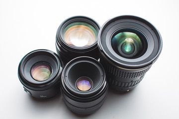 close-up view of a group of camera lenses on a white surface