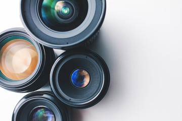 close-up view of a group of camera lenses on a white surface