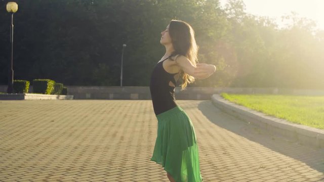 Young woman dancing on the square