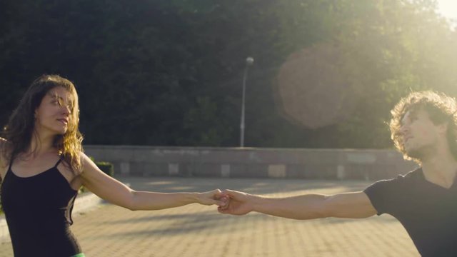 Young couple dancing on the square