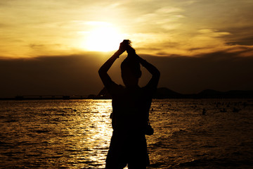 Shadow of woman on the beach with sunset