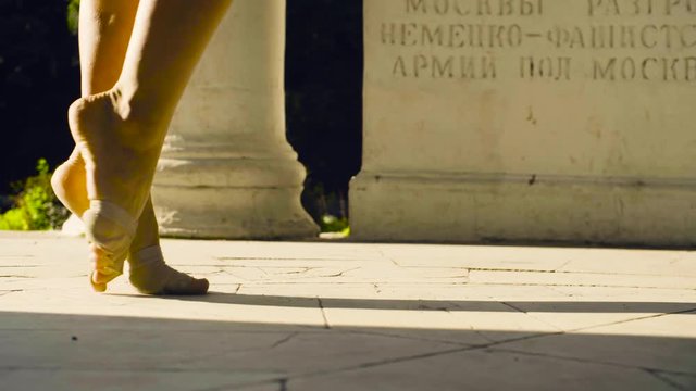 Bare feet of a woman dancing on a stone floor