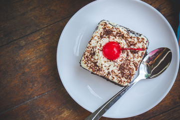 tasty chocolate cherry cake dessert on wood table