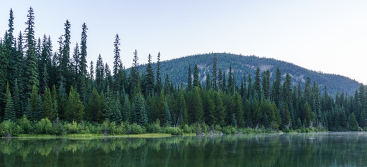 Mountain lake in mountains at sunny day British Columbia Canada.