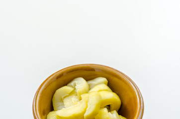 mango compote in brown bowl on white background