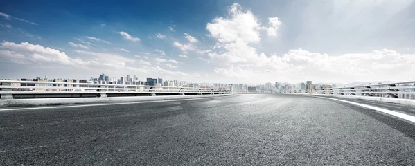 Foto op Canvas empty road and cityscape of modern city against cloud sky © zhu difeng