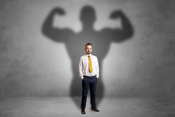 Businessman with muscular shade behind his back