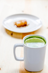 Dessert and Milk green tea on wooden table
