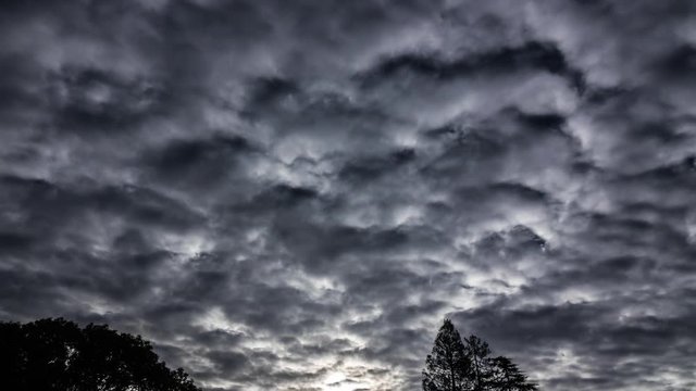 Dramatic clouds passing on the dar sky - timelapse