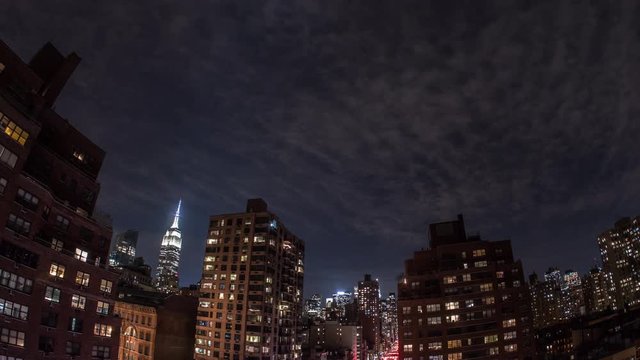 Time lapse of New York at night with clouds passing by over the sky