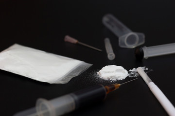 Fake Heroin or diacetylmorphine bag and syringes placed side by side. Low key addictive substance...