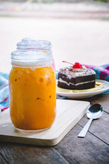 thai tea milkshake and pink milkshake beverage and cake chocolate dessert on wood table