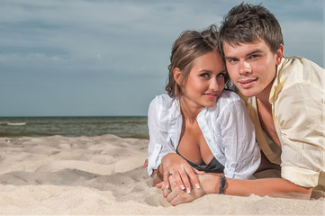 happy couple enjoying vacations on the beach