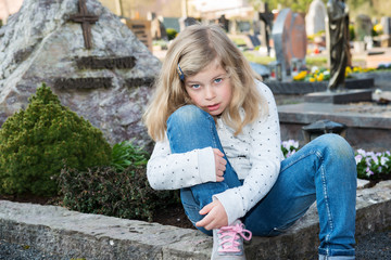 sad girl in front of grave