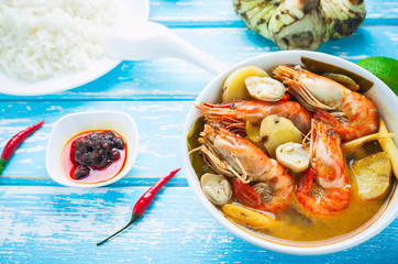 Thai food, River prawn spicy soup or tom yum goong on wooden table