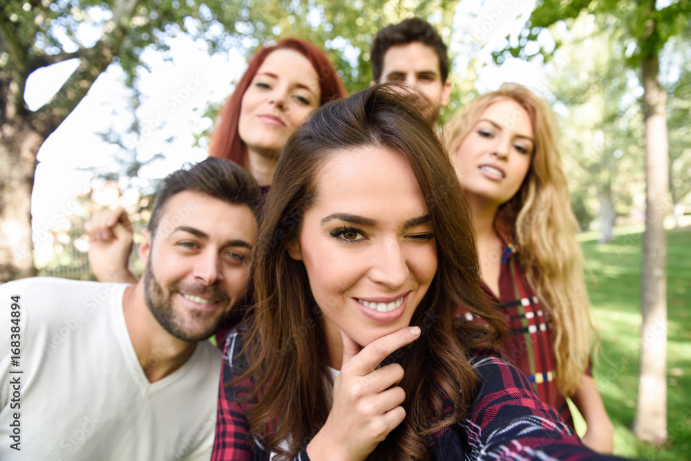 Wall mural Group of friends taking selfie in urban background