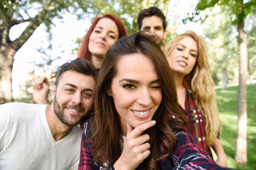 Group of friends taking selfie in urban background