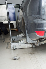 replacing the wheels on the SRT. the car is lifted on two jacks