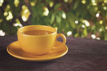 yellow cup of green tea on the table in the gazebo