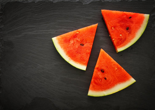 Image of fresh sliced watermelon on slate stone plate