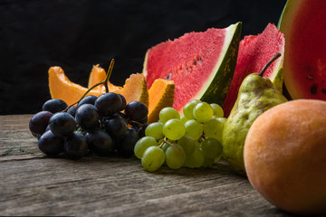 Watermelon, melon, grapes, peach, Pear, pumpkin on old wooden table