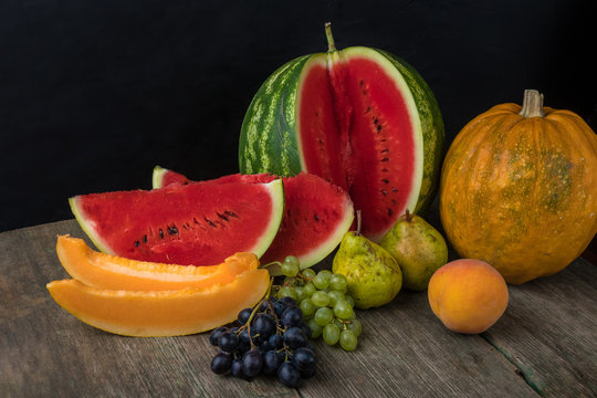 Watermelon, melon, grapes, peach, Pear, pumpkin on old wooden table