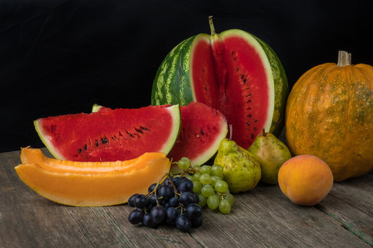 Watermelon, melon, grapes, peach, Pear, pumpkin on old wooden table